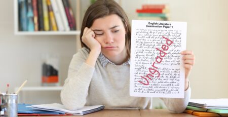 A sad student reviewing her English literature exam paper results.